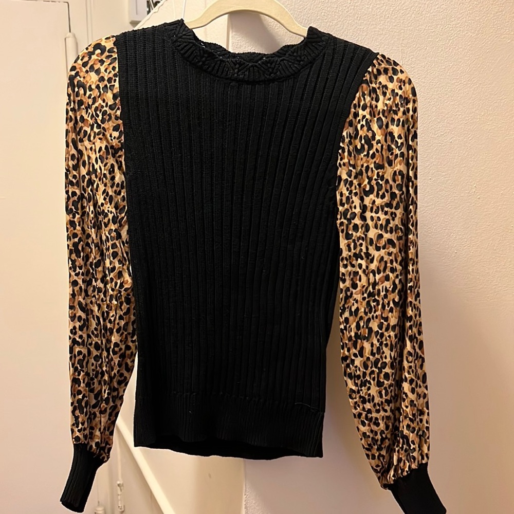 Black top with cheetah print sleeves